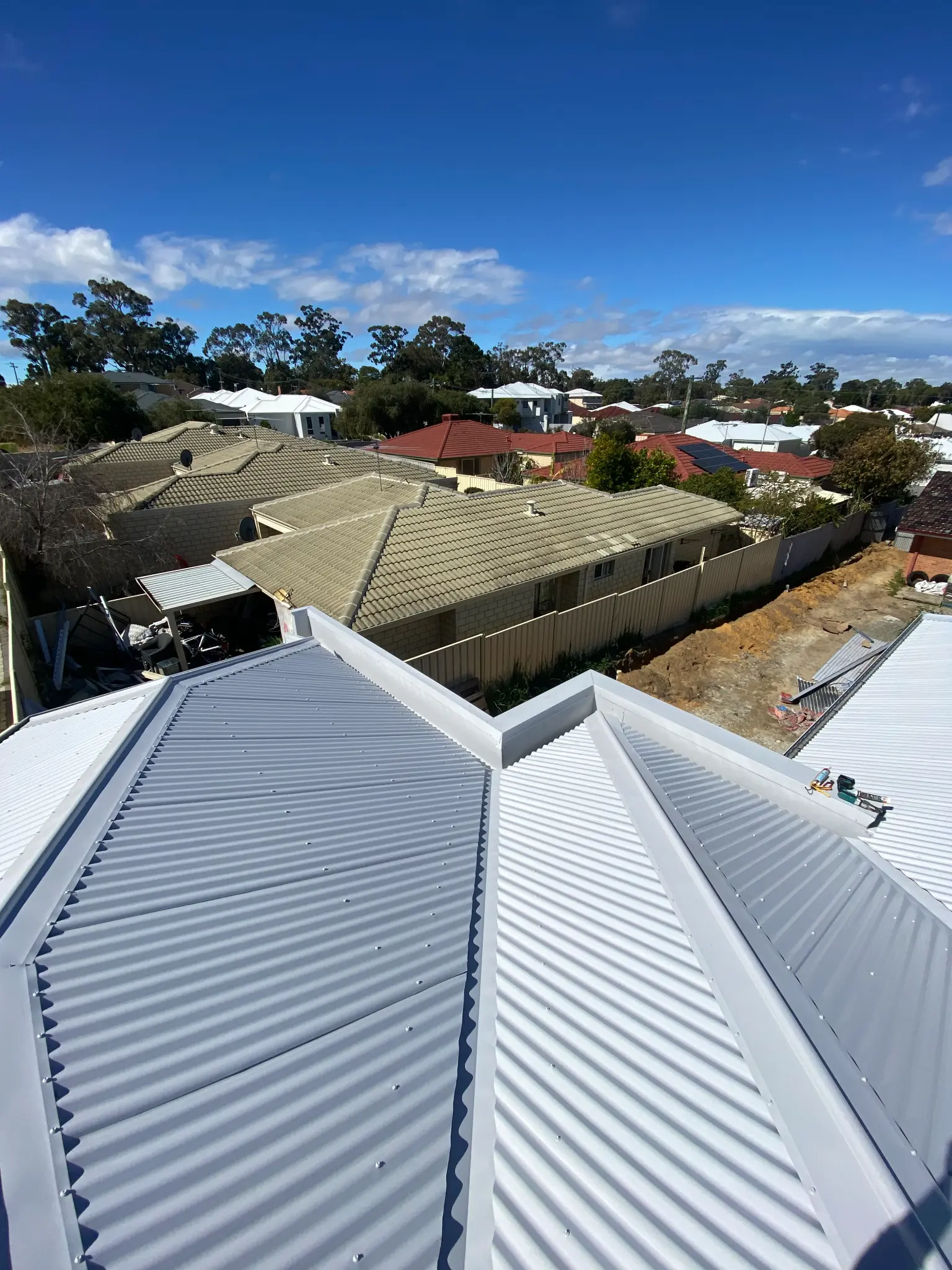 White metal roof with crisp ridge detailing